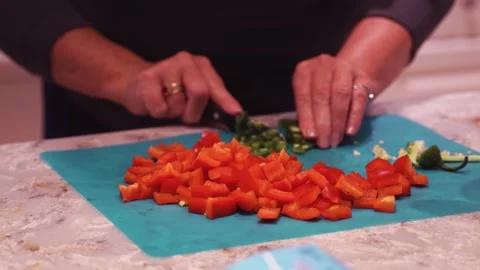 Close up and slo mo of cutting tomatoes and peppers Stock Footage 135950427