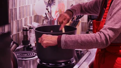 Close up and slo mo of hands stirring pot Stock Footage 134950416