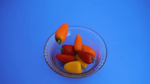 Close up and slow motion shot of red, yellow, and orange bell peppers Stock Footage 135950593