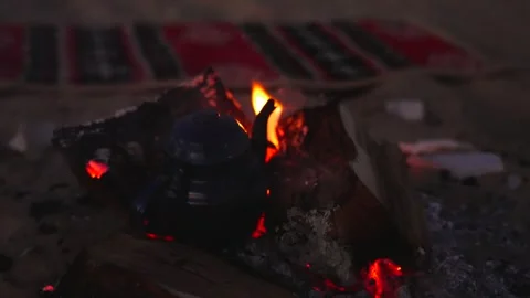 Close Up and Tea Kettle inside Glowing Campfire Embers and Flames at Night in Stock Footage 341994891