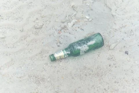 Close up and top view of a bottle of beer floating under the sea Stock Photos