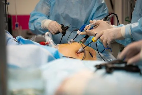 Close up ands of surgeons during operation with surgical laparoscopy instruments Stock Photos