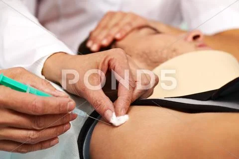 Close-up of anesthetic in syringe being injected into an injured Stock Photos