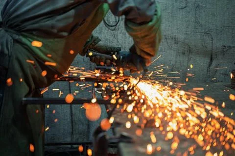 Close-Up of Angle Grinder Creating Sparks in Metal Workshop Stock Photos