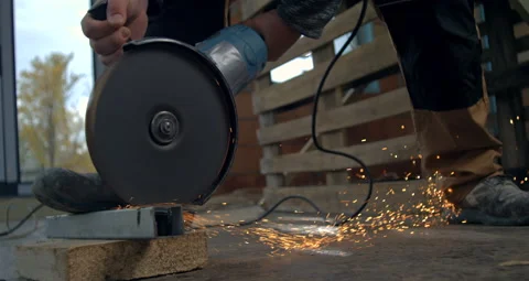 Close-up of angle grinder cutting metal block, sparks flying on constructio.. 스톡 동영상 291475612