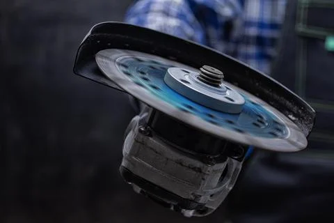 Close up of angle grinder with rotating cutting disc during metal processin.. Stock Photos