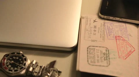 Close angle - pan of laptop, smartphone, passport Vidéo 49671722