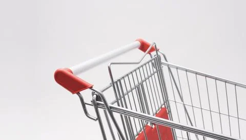 Close Up Angle View of Empty Shopping Cart Handle with Red Accents Photos