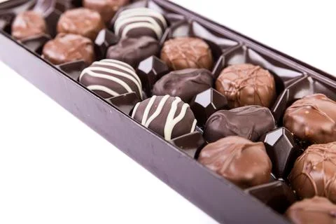 Close up angled view of a box of milk and dark striped chocolates Stock Photos