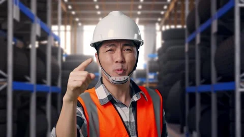 Close Up Of Angry Asian Male Engineer Shouting At Someone at Tire Warehouse Stock Footage 341786987