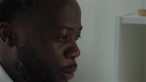 Close Up Of Angry Black Male Worker In Heated Debate Over Video Call At Home Stock Footage 319995919