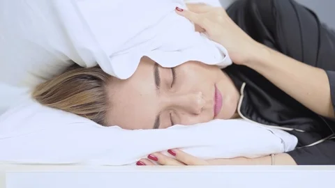 Close up angry can't sleep because noisy in home and turns from side to side Stock Footage 121065306