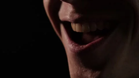 Close-up of angry laugh. Macro shot of mouth of a mad angry man smiling Stock Footage 305582048
