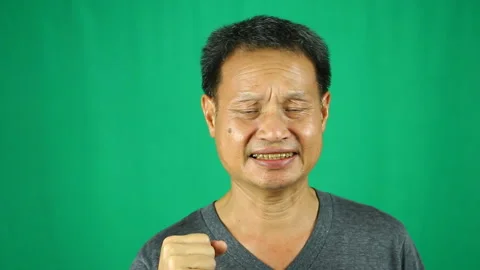 Close up angry  man with green background Stock Footage 139741853