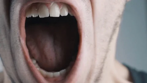 Close-up of angry man screaming against white background Vídeos de archivo 72742944