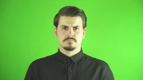 Close-up of angry young man screaming to camera. Greenbox background. Stock Footage 76203384
