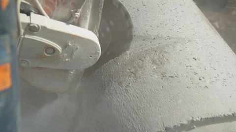 CLOSE UP: Angular saw grinding through a concrete tube at a construction site. Stock Footage 111729844