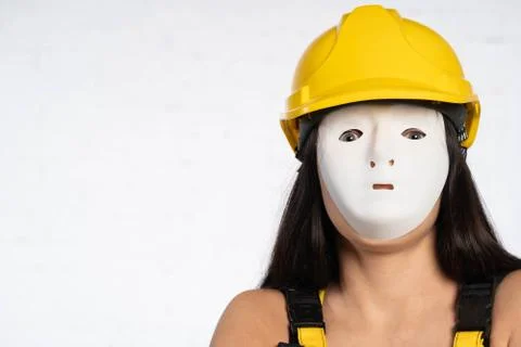 Close up anonymous face of a construction worker. Yellow protective helmet on 写真素材