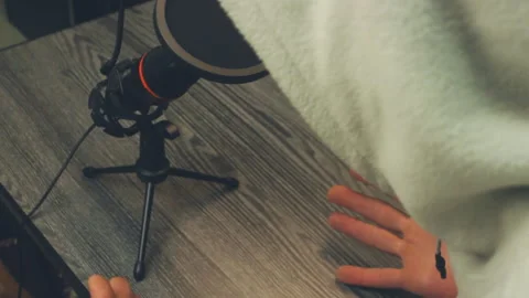 Close Up Anonymous Person Speaking Into Microphone On Wooden Desk Stock Footage 331098929