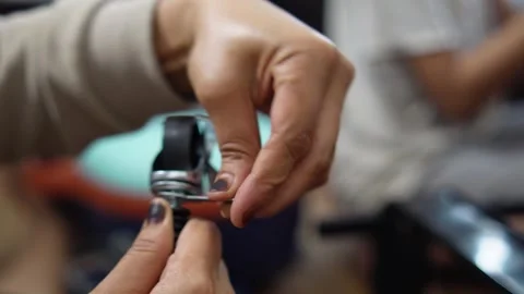 Close up of an anonymous woman hands assembling and installing wheels onto .. Stock Footage 330281955