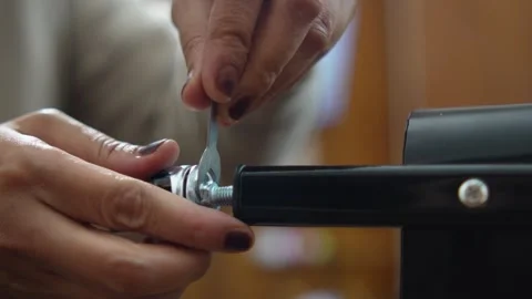 Close up of an anonymous woman hands assembling and installing wheels onto .. Vídeo Stock 330281970