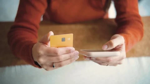 Close-up of an anonymous woman’s hands making an online purchase with a credit c Stock Footage 346321576