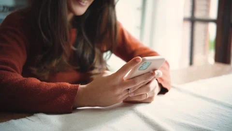 Close-up of an anonymous woman’s hands using a smartphone at home Stock Footage 346321434