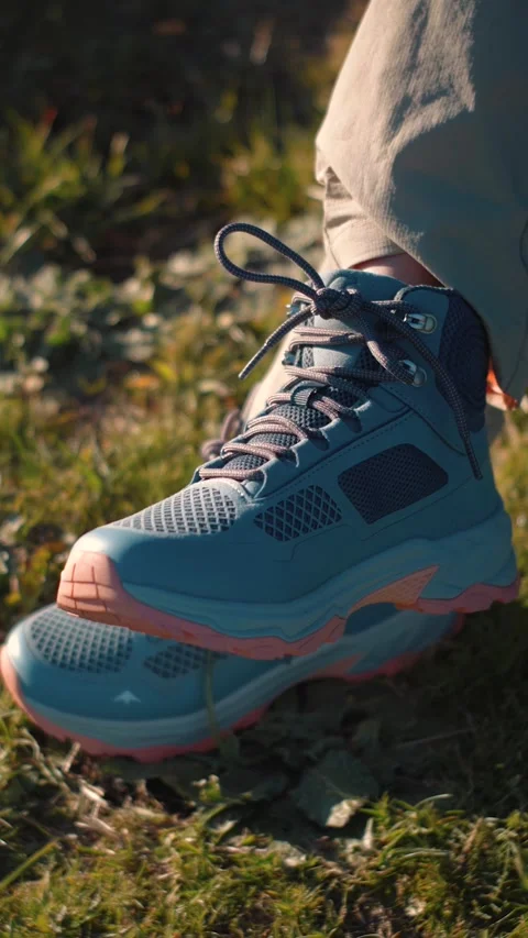 Close-up of an anonymous woman's hiking boots in nature, representing outdoor ad Stock Footage 346655300