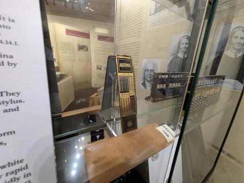 Close-up of antique calculating tools displayed behind glass Stock-Fotos
