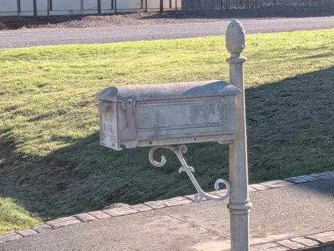 Close-up of antique rusty mailbox with ornate design Stock Photos