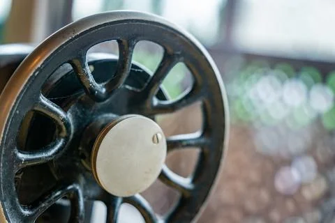 Close-Up of an Antique Sewing Machine Wheel With a White Knob Stock Photos