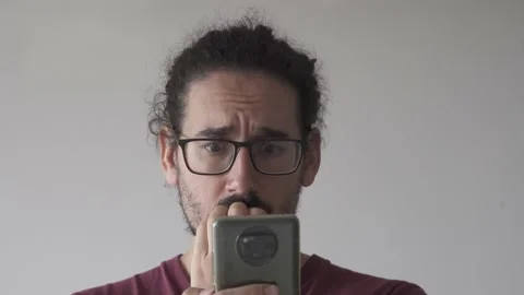 Close up of anxious man looking at smartphone and biting his nails Stock Footage 161552135