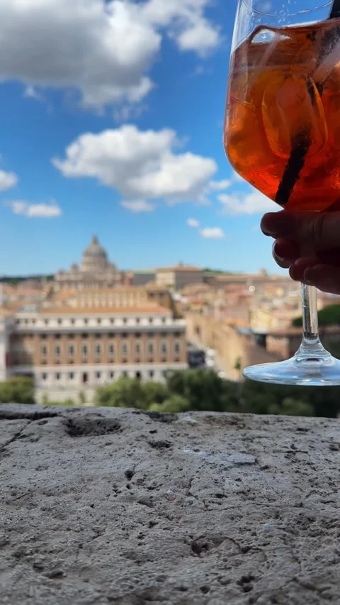 Close-Up of Aperol Spritz Glass with Focus Shift to the Vatican Stock Footage 340411367