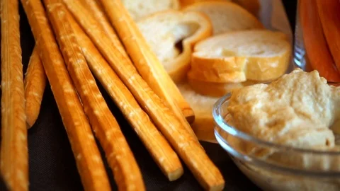 Close up, appetizer hummus, bread slices, breadsticks, and bagels Stock Footage 112226602