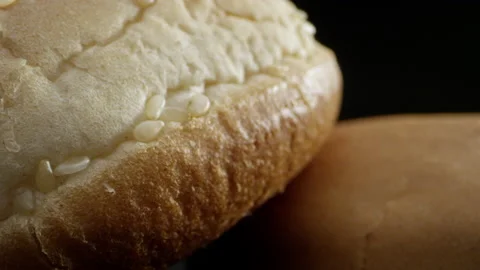 Close-up of an appetizing bread roll. Close-up frame of small bread on a black Stock-Footage 138596999
