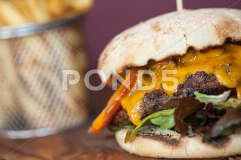 Close up on an appetizing cheeseburger Stock Photos