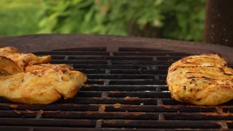 Close-up of the appetizing chicken fillet frying on the grill Stock Footage 148875168