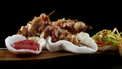 A close-up of an appetizing chicken skewer with bacon and sauce and salad. Close Video stock 138596653