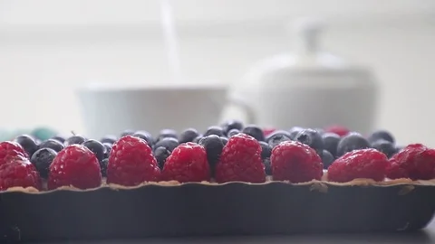 Close up of an appetizing homemade pie with blueberry and raspberry. in the back Stock Footage 112101730
