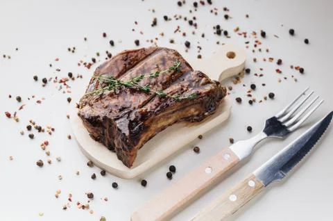 Close-up appetizing medium rar grilled t-bone steak on a wooden cutting board Stock Photos