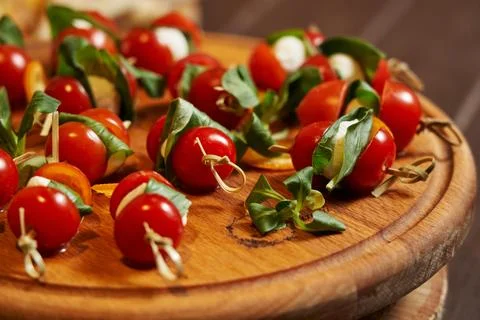 Close-up of appetizing red cherry tomatoes with mozzarella on skewers on a Stock Photos