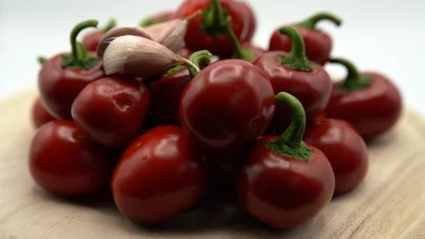 Close-up of appetizing red hot chili peppers with garlic rotating. Vegan eating Stock Footage 118883138