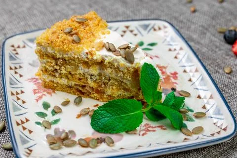 Close-up of appetizing slice of homemade pumpkin cake with sour cream and Stock Photos