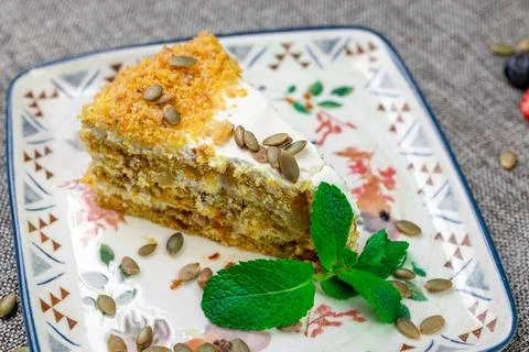 Close-up of appetizing slice of homemade pumpkin cake with sour cream and Stock Photos