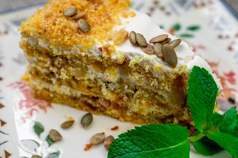 Close-up of appetizing slice of homemade pumpkin cake with sour cream and Stock Photos