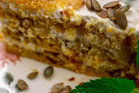 Close-up of appetizing slice of homemade pumpkin cake with sour cream and Stock Photos