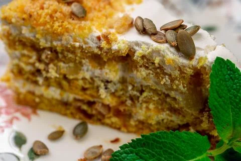 Close-up of appetizing slice of homemade pumpkin cake with sour cream and Stock Photos