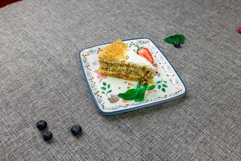Close-up of appetizing slice of homemade pumpkin cake with sour cream and Stock Photos