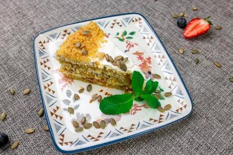 Close-up of appetizing slice of homemade pumpkin cake with sour cream and Stock Photos