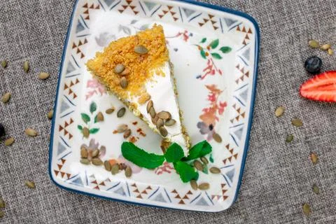 Close-up of appetizing slice of homemade pumpkin cake with sour cream and Stock Photos